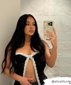 girl taking mirror selfie with gold phone case