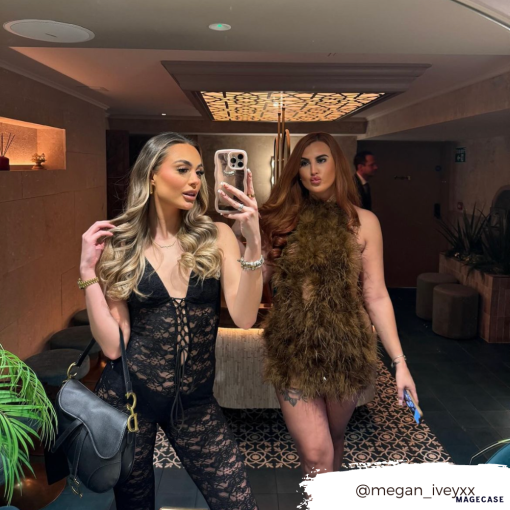 Two women are posing in a stylish, well-lit lobby area. The woman in front is taking a mirror selfie with her phone, which has a Coconut Lane Curvy Mirror Phone Case - Pink. She is wearing a black lace outfit and carrying a black handbag. The woman behind her is wearing a fur-like dress. Instagram handle @megan_iveyxx is overlaid.