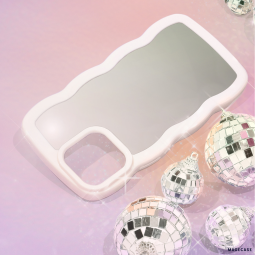A sleek and stylish Curvy Mirror Phone Case - Cream from Coconut Lane lies on a pink and purple gradient background. Surrounding the curvy mirror phone case are several shiny, mirrored disco ball ornaments of varying sizes, reflecting light and casting a festive, glamorous feel to the image.