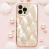 A smartphone adorned with Coconut Lane's Real Natural Shell Phone Case - White rests on a pastel pink background, surrounded by scattered white seashells and pearls, creating a coastal, elegant aesthetic.