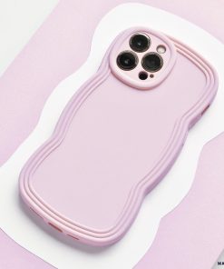 A NAKD Curvy Phone Case - Blueberry by Coconut Lane with a wavy, textured design is shown from the back. The lightweight case has precise cutouts for the camera lenses and buttons. The background features a light pink and white abstract pattern.