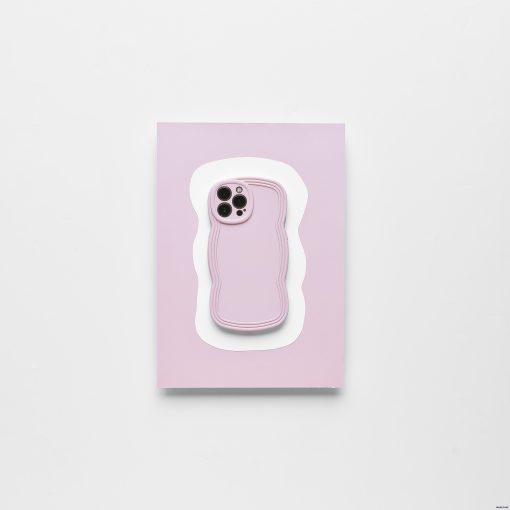 A smartphone with a Blueberry protective case from Coconut Lane lies on top of a light pink and white wavy-edged mat against a plain white background. The lightweight NAKD Curvy Phone Case highlights the phone camera cutout, making it both stylish and functional.