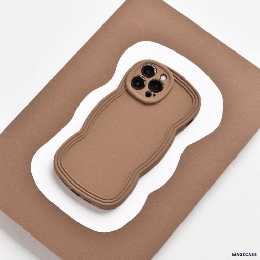 A lightweight, brown NAKD Curvy Phone Case - Coffee from Coconut Lane with a wavy design lies on a flat, brown and white, wavy-edged surface. The case has precise cutouts for the camera lenses and appears highly protective. The background contrasts with the NAKD Curvy Phone Case, highlighting its unique shape and design.
