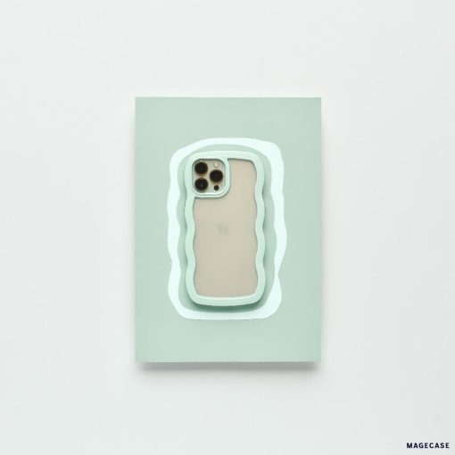 A modern iPhone 15 with a beige back and three camera lenses is placed on a pastel green rectangular surface. The surface features an irregular white and mint green outline, complementing the minimalistic setting. It is protected by the Mint Curvy Phone Case from Coconut Lane.