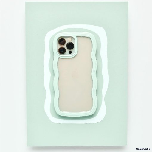 A mint green Curvy Phone Case - Mint by Coconut Lane with wavy edges holds an iPhone 15 featuring three cameras on the back. The protective case is set against a matching light green wavy background, creating a layered visual effect.