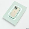 A gold iPhone, identified as an iPhone15, is encased in the rugged and wavy-edged Coconut Lane Curvy Phone Case in Mint. It's placed on a light green rectangular surface with a precise cutout that fits the phone perfectly. The camera lenses and Apple logo remain visible through the protective case.
