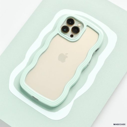 A beige iPhone 15 with three camera lenses on the back is placed on a mint green surface. The phone is encased in a Coconut Lane Curvy Phone Case - Mint, perfectly matching the surface color.