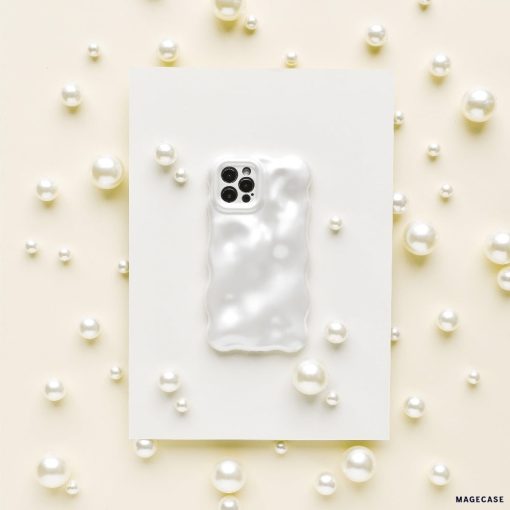 A Coconut Lane 3D Pearl Phone Case in white, featuring a glossy, wavy, pearl effect, is placed on a white rectangular sheet. The sheet is surrounded by various sizes of white pearls scattered on a light beige surface, creating an elegant and sophisticated display.
