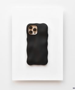 A Coconut Lane smartphone enclosed in a 3D Boujee Phone Case - Matte Black is placed on a white surface. The phone's rear camera, featuring three lenses and a flash, is visible through a cutout in the extra protective case. The overall layout exudes a minimalist and modern aesthetic.