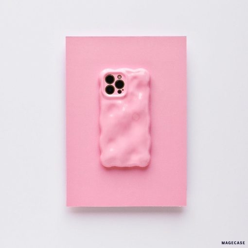 A 3D Gummy Phone Case - Pink by Coconut Lane is displayed on a pink background. This chic phone case, with its wavy, bubble-like design and glossy finish, features cutouts for the camera lenses. It offers extra protective coverage while maintaining a minimalist aesthetic with a cohesive pink theme.