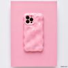 A chic and colorful upgrade, this smartphone features the Coconut Lane 3D Gummy Phone Case - Pink, showcasing a textured pink design with a melting effect set against a matching pink background. The unique, irregular surface enhances the phone's triple camera setup visible at the top left corner.