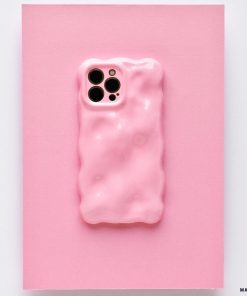 A chic and colorful upgrade, this smartphone features the Coconut Lane 3D Gummy Phone Case - Pink, showcasing a textured pink design with a melting effect set against a matching pink background. The unique, irregular surface enhances the phone's triple camera setup visible at the top left corner.