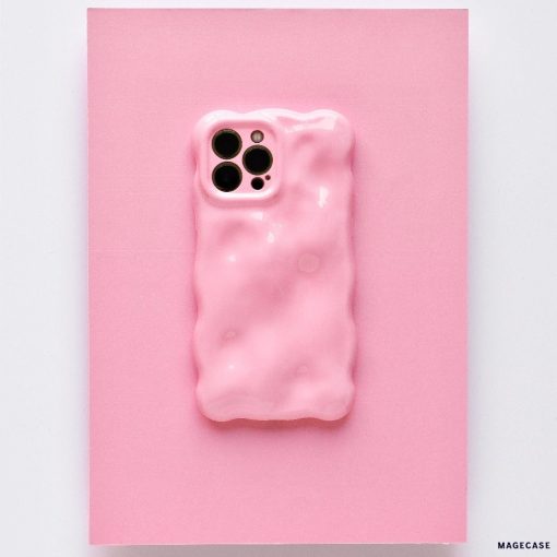A chic and colorful upgrade, this smartphone features the Coconut Lane 3D Gummy Phone Case - Pink, showcasing a textured pink design with a melting effect set against a matching pink background. The unique, irregular surface enhances the phone's triple camera setup visible at the top left corner.