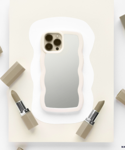 A sleek and stylish iPhone adorned with the Coconut Lane Curvy Mirror Phone Case in Cream is centered on a piece of off-white paper. The phone's camera is visible, reflecting off the back of the case. Surrounding the device are six muted beige lipsticks, some with their caps removed, arranged in a circular pattern.