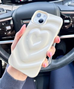 A hand with pink-painted nails holds a smartphone encased in the 